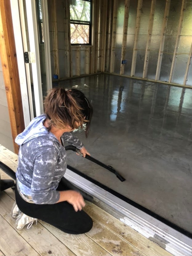 Man sweeping concrete floor